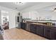 Kitchen showcases stainless steel appliances, dark cabinets, brick backsplash, and open layout at 113 Plumeria St, Canton, GA 30114