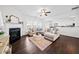 Comfortable living room with fireplace, plush sectional sofa, and dark hardwood floors at 113 Plumeria St, Canton, GA 30114
