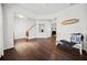 Spacious living area with hardwood floors, a cozy bench, and view of the fireplace at 113 Plumeria St, Canton, GA 30114