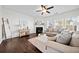 Cozy living room with a fireplace, plush sofa, ceiling fan, and plenty of natural light at 113 Plumeria St, Canton, GA 30114