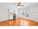 Bright office space with a built-in desk, hardwood floors, natural light, and an overhead ceiling fan at 113 Plumeria St, Canton, GA 30114