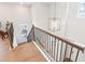 Open staircase with wooden banister and a stylish light fixture at 3503 Creek Holw, Buford, GA 30519