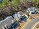 Aerial shot of a home in a well-maintained neighborhood, surrounded by mature trees and manicured lawns at 617 Oakbourne Way, Woodstock, GA 30188