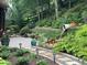 Landscaped backyard featuring a water feature with lush greenery and a stone walkway at 617 Oakbourne Way, Woodstock, GA 30188