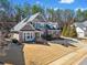 Attractive two-story home with a combination of stone and siding, a well-kept lawn and mature trees at 617 Oakbourne Way, Woodstock, GA 30188