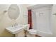 Cozy bathroom featuring a pedestal sink, round mirror, and subway tiled shower at 970 Drewry Ne St, Atlanta, GA 30306