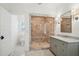 Beautiful bathroom showcasing a frameless glass shower with marble surround and gray vanity at 970 Drewry Ne St, Atlanta, GA 30306