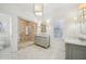 Spa-like bathroom with double vanities, marble shower, and herringbone tile floor at 970 Drewry Ne St, Atlanta, GA 30306