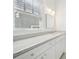 Bathroom featuring white marble countertops and vanity with double sinks and window at 970 Drewry Ne St, Atlanta, GA 30306