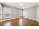 Bedroom with hardwood flooring, white trim, baseboards and crown molding with two windows at 970 Drewry Ne St, Atlanta, GA 30306