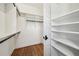Walk-in closet featuring custom organizers, built-in shelving and stylish wood floors at 970 Drewry Ne St, Atlanta, GA 30306