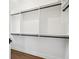 Walk-in closet features built in shelving and rod with wood flooring and dark hardware at 970 Drewry Ne St, Atlanta, GA 30306