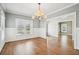 Bright dining room with hardwood floors, chandelier, wainscoting and large windows at 970 Drewry Ne St, Atlanta, GA 30306