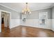 Formal dining room with hardwood flooring, wainscoting and a modern chandelier at 970 Drewry Ne St, Atlanta, GA 30306