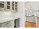 Butler's pantry with sleek cabinetry, countertop space, and hardwood floors at 970 Drewry Ne St, Atlanta, GA 30306