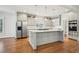 A gourmet kitchen featuring stainless steel appliances, a large island, and custom cabinetry at 970 Drewry Ne St, Atlanta, GA 30306