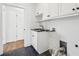 Laundry room with white cabinets, dark countertops and slate tile floor at 970 Drewry Ne St, Atlanta, GA 30306