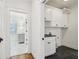 Hallway view of a laundry room, features cabinets and dark tile at 970 Drewry Ne St, Atlanta, GA 30306