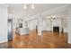 Open-concept living area with modern kitchen, wood floors, and built-in shelving around a fireplace at 970 Drewry Ne St, Atlanta, GA 30306