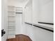 Walk-in closet with custom white shelving and black rod at 970 Drewry Ne St, Atlanta, GA 30306