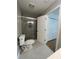 Renovated bathroom featuring a glass-enclosed shower, tile floors and new toilet at 1039 Whitfield Se Ct, Smyrna, GA 30080