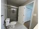 Bright bathroom featuring a glass enclosed shower, white tile floor, and a modern toilet at 1039 Whitfield Se Ct, Smyrna, GA 30080