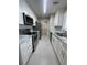 Modern kitchen with stainless steel appliances, white cabinetry, and elegant marble countertops at 1039 Whitfield Se Ct, Smyrna, GA 30080