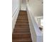 Wooden staircase leading to the upper level, complemented by white railings and natural light at 1039 Whitfield Se Ct, Smyrna, GA 30080