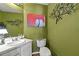 Well-lit bathroom with a clean vanity, modern faucet, and decorative wall art at 1267 Huntington Place Cir, Lithonia, GA 30058