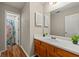 Bathroom features a vanity with a sink and a view into the shower at 1267 Huntington Place Cir, Lithonia, GA 30058