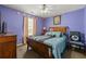 Cozy bedroom featuring a comfortable bed with colorful pillows and a ceiling fan at 1267 Huntington Place Cir, Lithonia, GA 30058