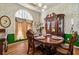 Elegant dining room with classic decor, wallpaper, and a window with natural light at 1267 Huntington Place Cir, Lithonia, GA 30058