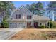 Charming two-story home featuring a two-car garage and mature trees in a serene neighborhood at 1267 Huntington Place Cir, Lithonia, GA 30058