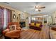 Cozy living room featuring hardwood floors, fireplace, and seamless flow into kitchen at 1267 Huntington Place Cir, Lithonia, GA 30058