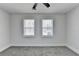 This bedroom features neutral walls, gray carpet and a ceiling fan with a light at 2767 3Rd Sw Ave, Atlanta, GA 30315