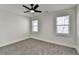 This bedroom features neutral walls, gray carpet and a ceiling fan with a light at 2767 3Rd Sw Ave, Atlanta, GA 30315