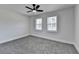 This bedroom features neutral walls, gray carpet and a ceiling fan with a light at 2767 3Rd Sw Ave, Atlanta, GA 30315