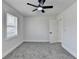 This bedroom features neutral walls, gray carpet and a ceiling fan with a light at 2767 3Rd Sw Ave, Atlanta, GA 30315