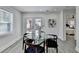 Dining area with table, four chairs, backyard access through double doors, and a view into the main bedroom at 2767 3Rd Sw Ave, Atlanta, GA 30315