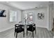 Dining area with table, four chairs, backyard access through double doors, and a window with wooded views at 2767 3Rd Sw Ave, Atlanta, GA 30315