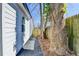 The side of the home showcases pristine white siding, complemented by an adjacent tree and a gated pathway at 2767 3Rd Sw Ave, Atlanta, GA 30315