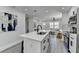 Modern kitchen with white cabinets, stainless steel appliances, quartz counters and large kitchen island overlooking the living room at 2767 3Rd Sw Ave, Atlanta, GA 30315