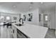 Kitchen featuring a large island with quartz countertop, stainless steel appliances, and access to dining room and back deck at 2767 3Rd Sw Ave, Atlanta, GA 30315