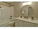 Bathroom with tiled tub, marble vanity, and ornate mirror at 2813 Long Grove Ct, Marietta, GA 30062