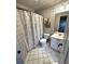 Bathroom with tile flooring, decorative wallpaper and shower featuring patterned curtain at 2813 Long Grove Ct, Marietta, GA 30062