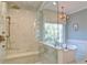 Spa-like bathroom with glass-enclosed shower, soaking tub, and elegant chandelier at 2813 Long Grove Ct, Marietta, GA 30062