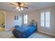 Bedroom featuring a bed with blue comforter, two shuttered windows, and views to adjoining room at 2813 Long Grove Ct, Marietta, GA 30062