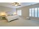 Bright bedroom featuring carpet flooring, shutters, and ceiling fan at 2813 Long Grove Ct, Marietta, GA 30062