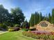 Madison Hall community entrance featuring lush landscaping, beautiful flowers, and brick signage at 2813 Long Grove Ct, Marietta, GA 30062