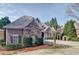 Charming home showcasing a stone and siding facade, complemented by lush landscaping and a welcoming driveway at 2813 Long Grove Ct, Marietta, GA 30062